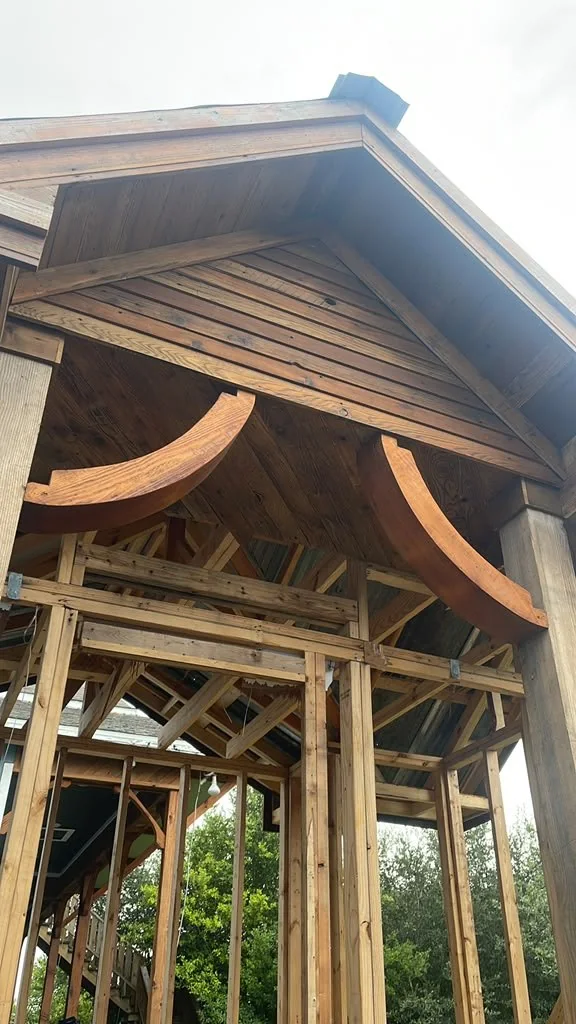 Curved cedar brackets and exposed rafters on a raised porch