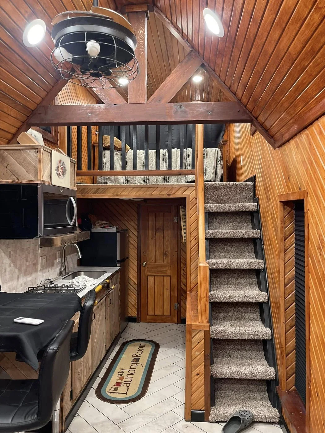 Tiny home interior with stairs up to the sleeping loft